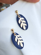 Load image into Gallery viewer, Navy and gold dangling earrings || leaf earrings || polymer clay earrings || handmade in Ireland || gifts for her - Dúil
